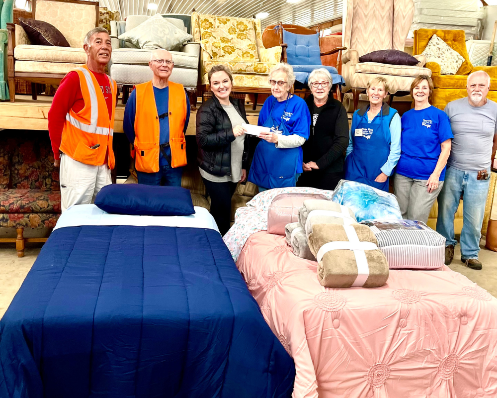 People Posing in Furniture Warehouse